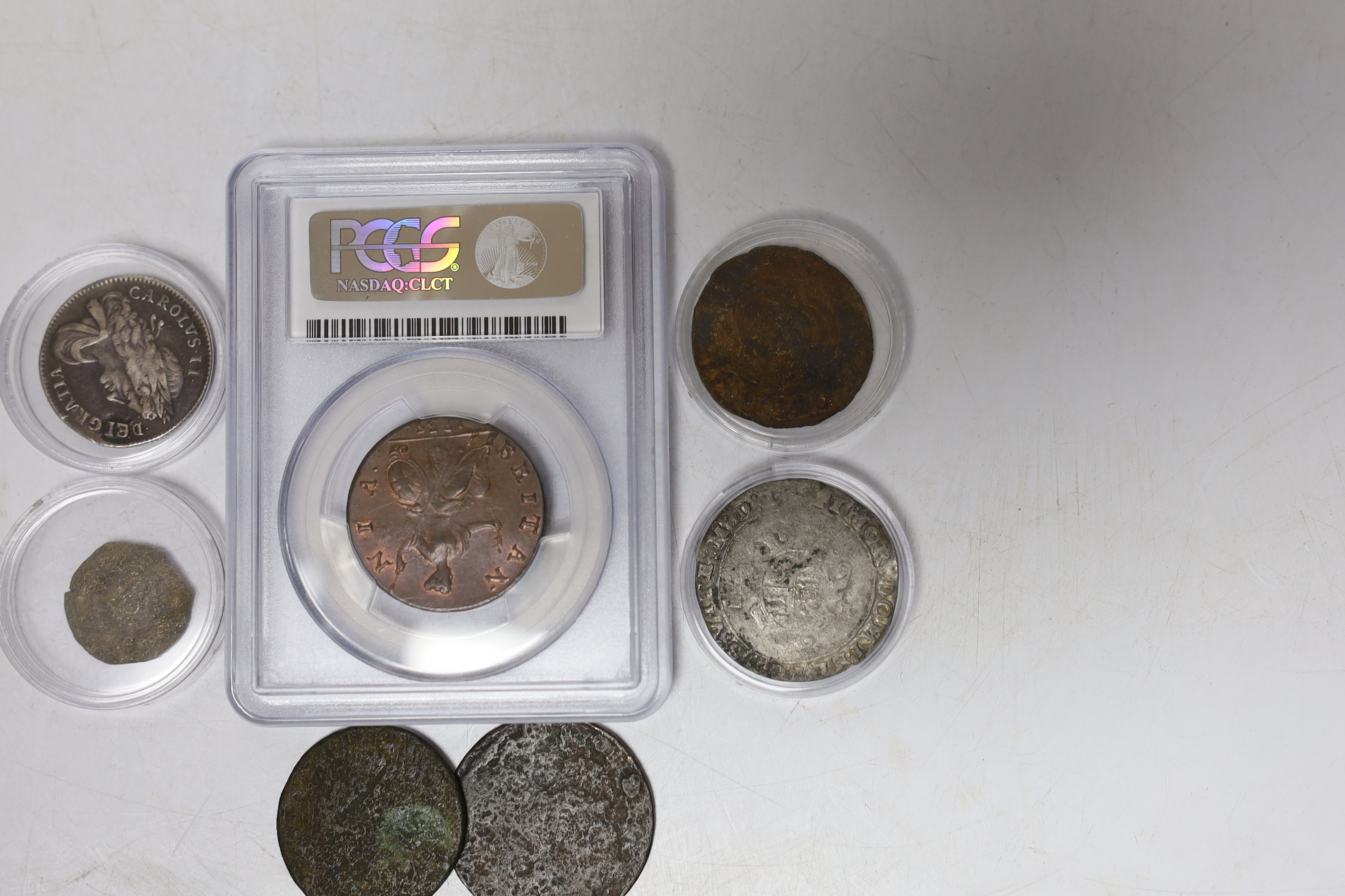 Seven coins including; a Charles II 1663 shilling, an Edward VI silver shilling, a George II 1735 half penny (PCGS graded MS65BN) together with four other coins